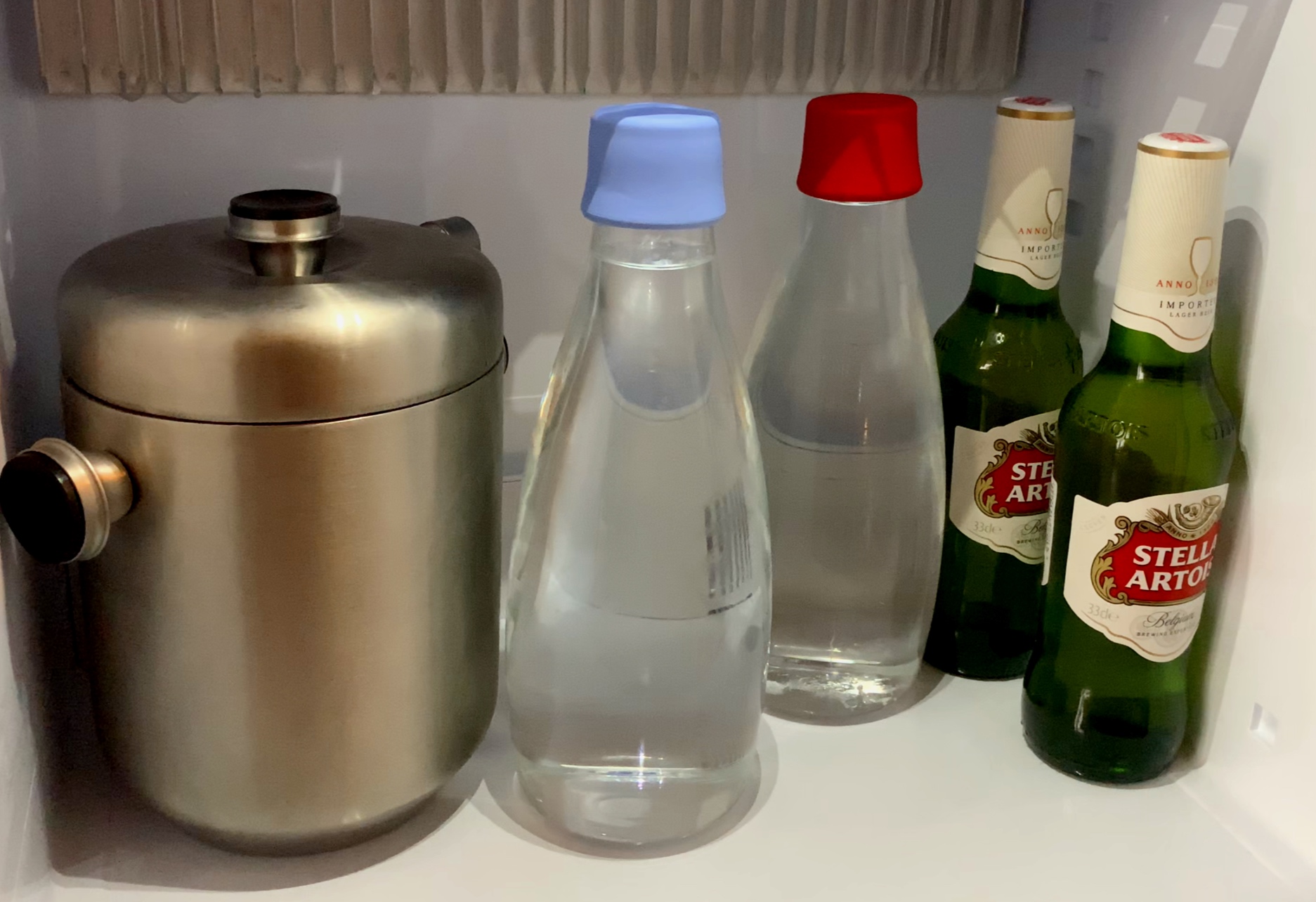 Re-fillable glass water bottles.