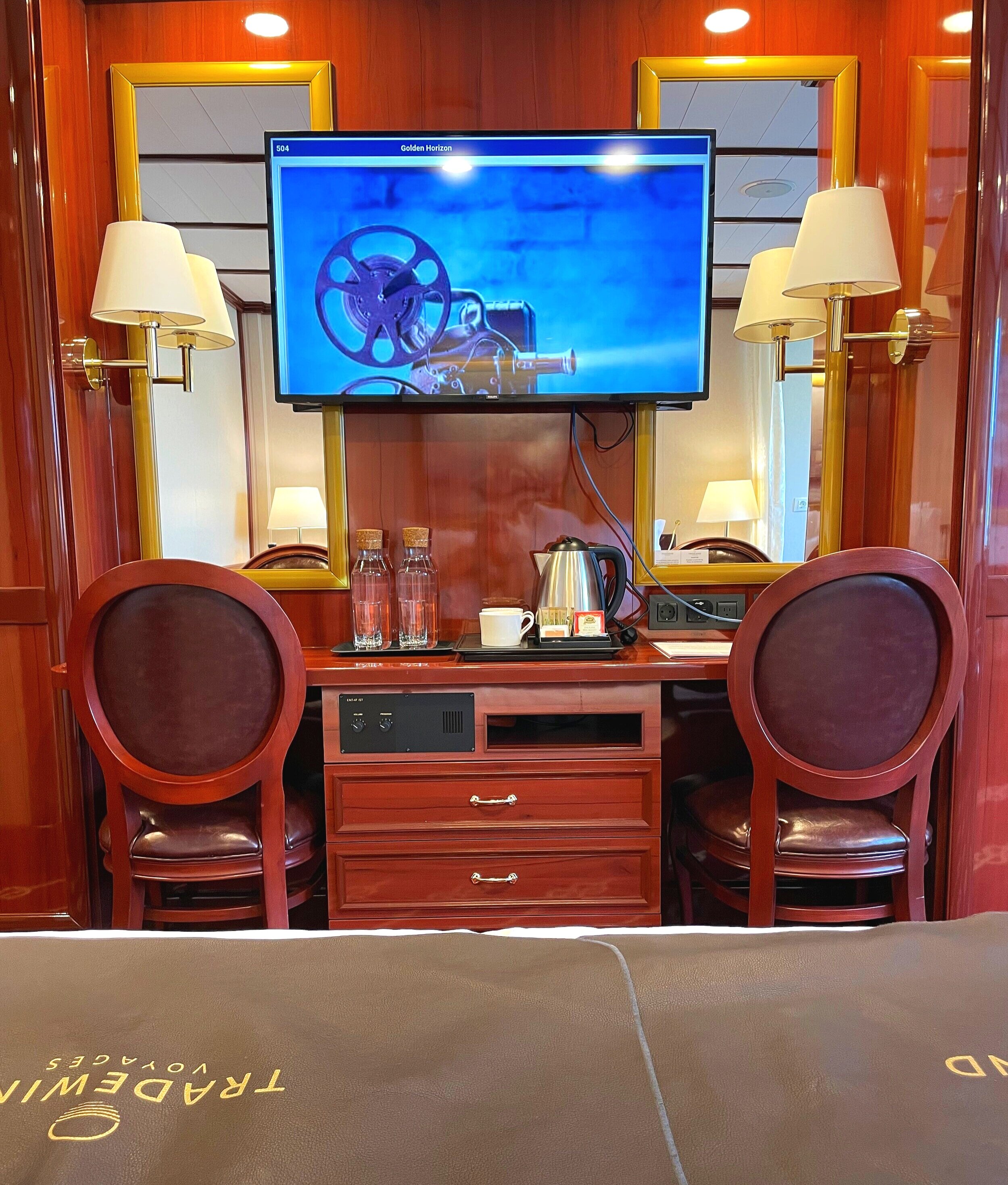  The desk and TV at the bottom of the bed 