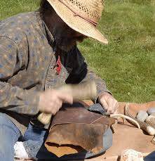 Charlie Paquin demonstrating the art of flint-knapping.