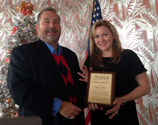 Kelly Marsh of Broadview Mortgage receives the Santa Barbara Association of Realtors’ Affiliate of the Year Award for 2014 from John Chufar, broker associate at Sterling Properties. (Broadview Mortgage photo)