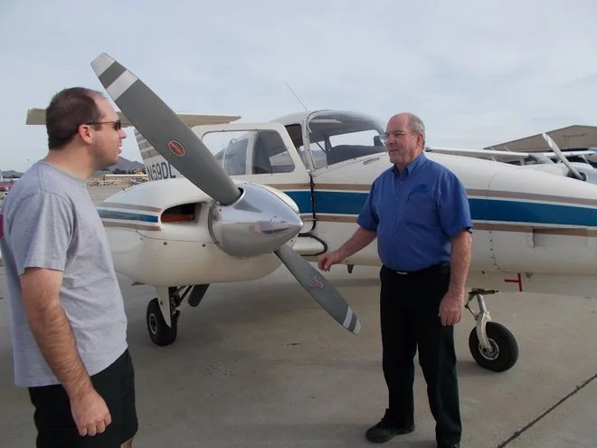 Channel Islands Aviation Flight School chief flight instructor David Koble (right) conducts a flight lesson with Danny Zarachoff, of Moorpark. The school has received examination approval from the Federal Aviation Administration.