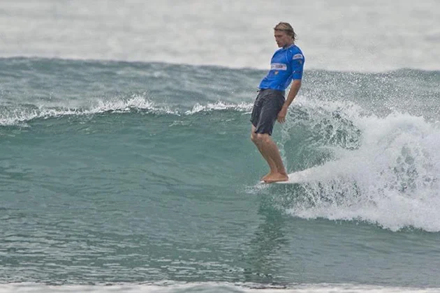 Cole Robbins hangs ten while longboarding in the 2012 CITIC PACIFIC ShenZhou Peninsula Pro. The surfer also works as a real estate agent at Village Properties. (World Surf League photo)