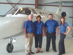 From left, Mark Oberman, Janie Oberman, Mike Oberman and Sarah Oberman Bartush pose in front of one their jets.