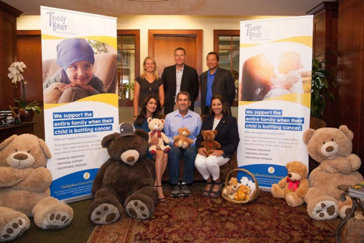 Helping to kick off off the teddy bear program are: Michelle Martinich, left, Rich Schuette, Robert Mislang, and seated, Sheela Hunt, left, Dave Edelman, Adriana Mezic. (American Riviera Bank)