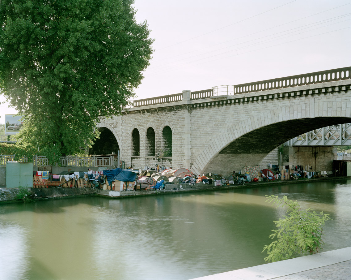   Roma #1 –&nbsp;  Aubervilliers, Seine-Saint-Denis, 2006. 40"x50"    l'habitat marginalisé artist's statement   Unlike the protesters, Roma set up their tent encampments as out-of-sight as possible. Outside the city in the banlieues, these encampmen