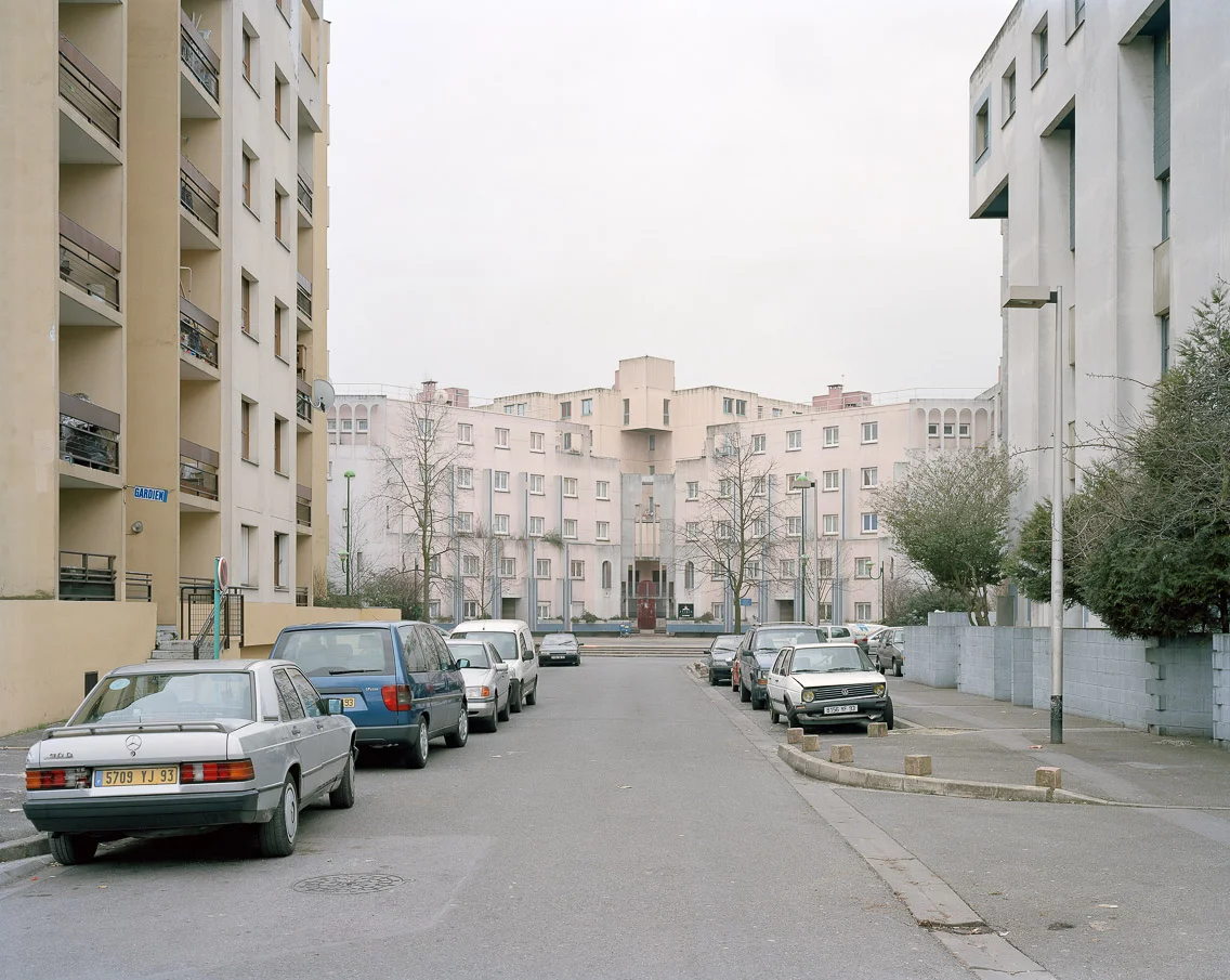 Banlieues #4 – Cité des Beaudottes, Sevran, Seine-Saint-Denis, 2006. 40"x50" l'habitat marginalisé artist's statement These streets were the ones that were littered with the smoldering husks of cars and busses – blocking traffic in both directions. Strangely enough, though the rioting occurred every night, during daylight the regular activity of the community continued as closely to normal as possible.