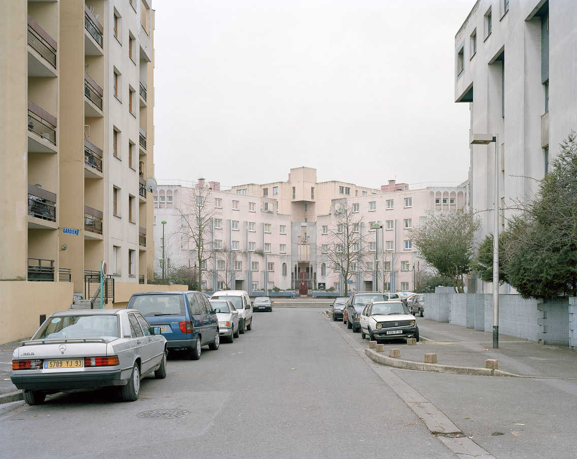  Banlieues #4 –&nbsp;Cité des Beaudottes, Sevran, Seine-Saint-Denis, 2006. 40"x50"   l'habitat marginalisé artist's statement   These streets were the ones that were littered with the smoldering husks of cars and busses – blocking traffic in both dir