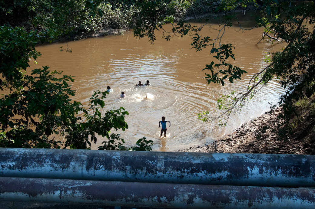 AW - Residents from the community of Taracoa bathing in a river that remains contaminated. In fact, say locals, the entire water supply is contaminated..jpg