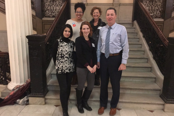 On the steps of the State House. Front row, Kameko Branchaud, PEM Connected Learning Developer, Kati Nalbandian, Feminists of Salem, Representative Paul Tucker. Back row, Donecca Thurston, PEM Creative Engagement Producer, Deborah Greel, Public Art Planner, City of Salem. Photo Creative Salem.