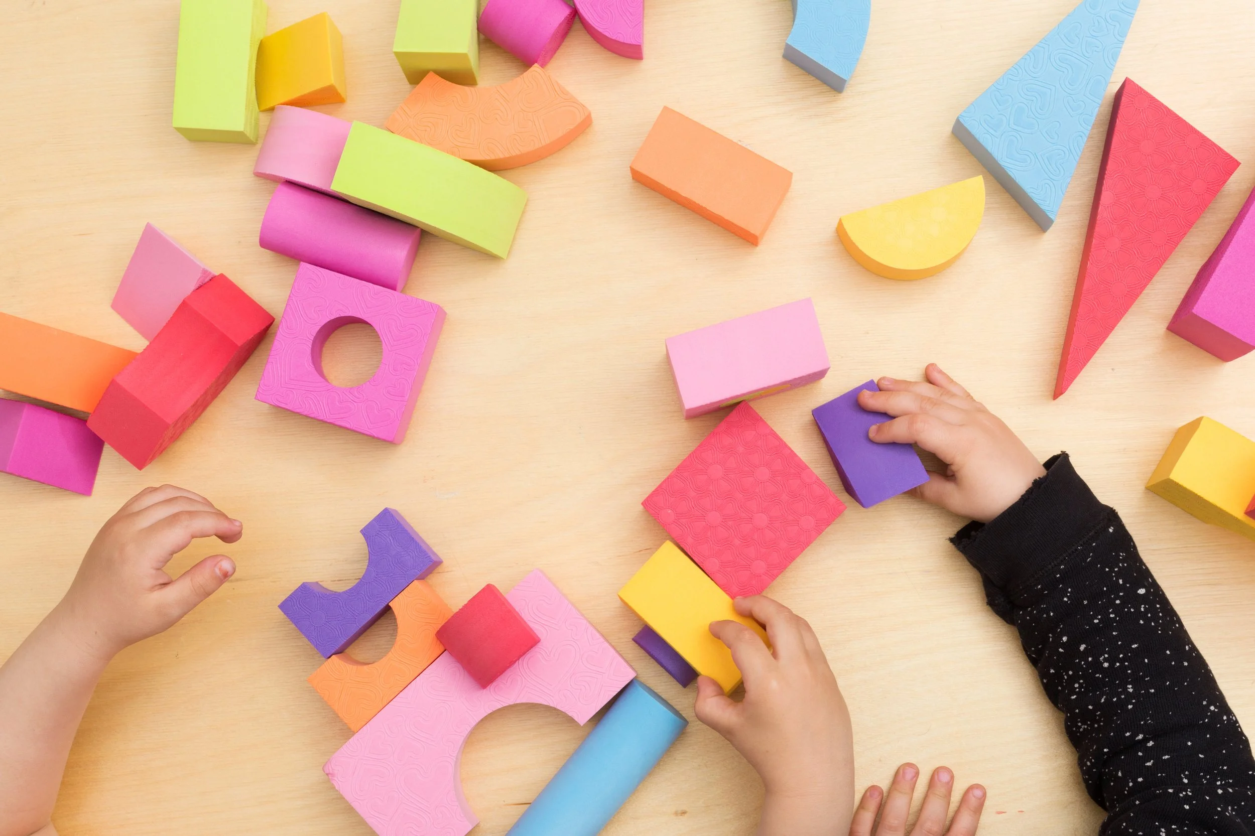 toddler-hands-playing-with-colorful-blocks.jpg
