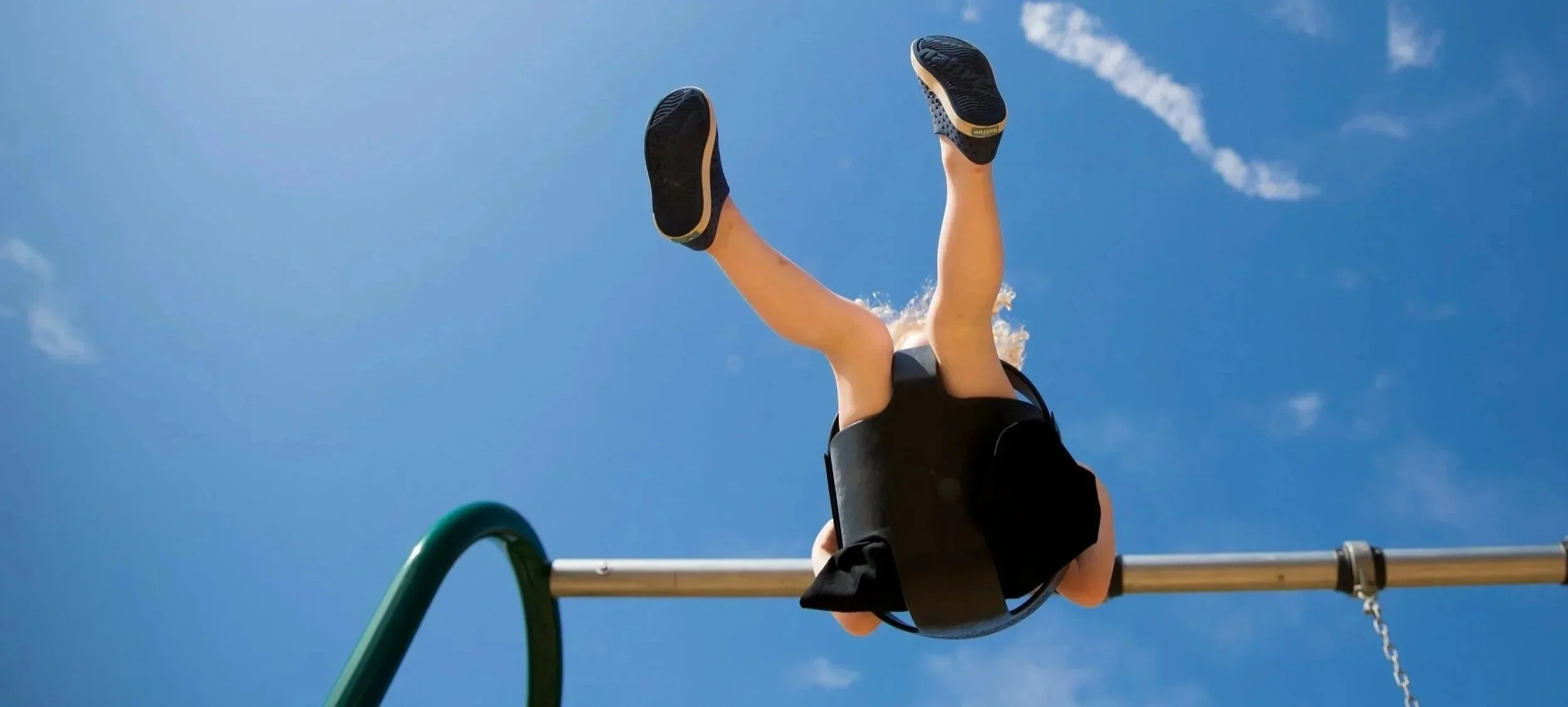 a-child-on-a-swing-under-a-blue-sky.jpg