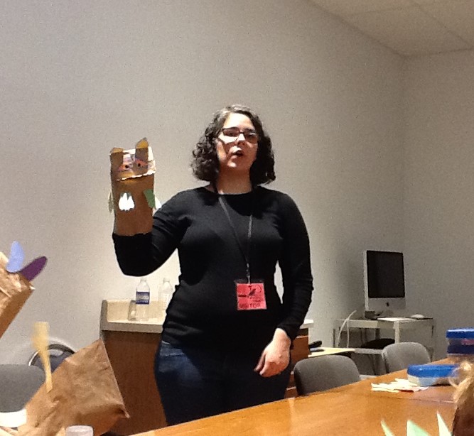 Megan teaching the kindergarteners how to use their new puppets