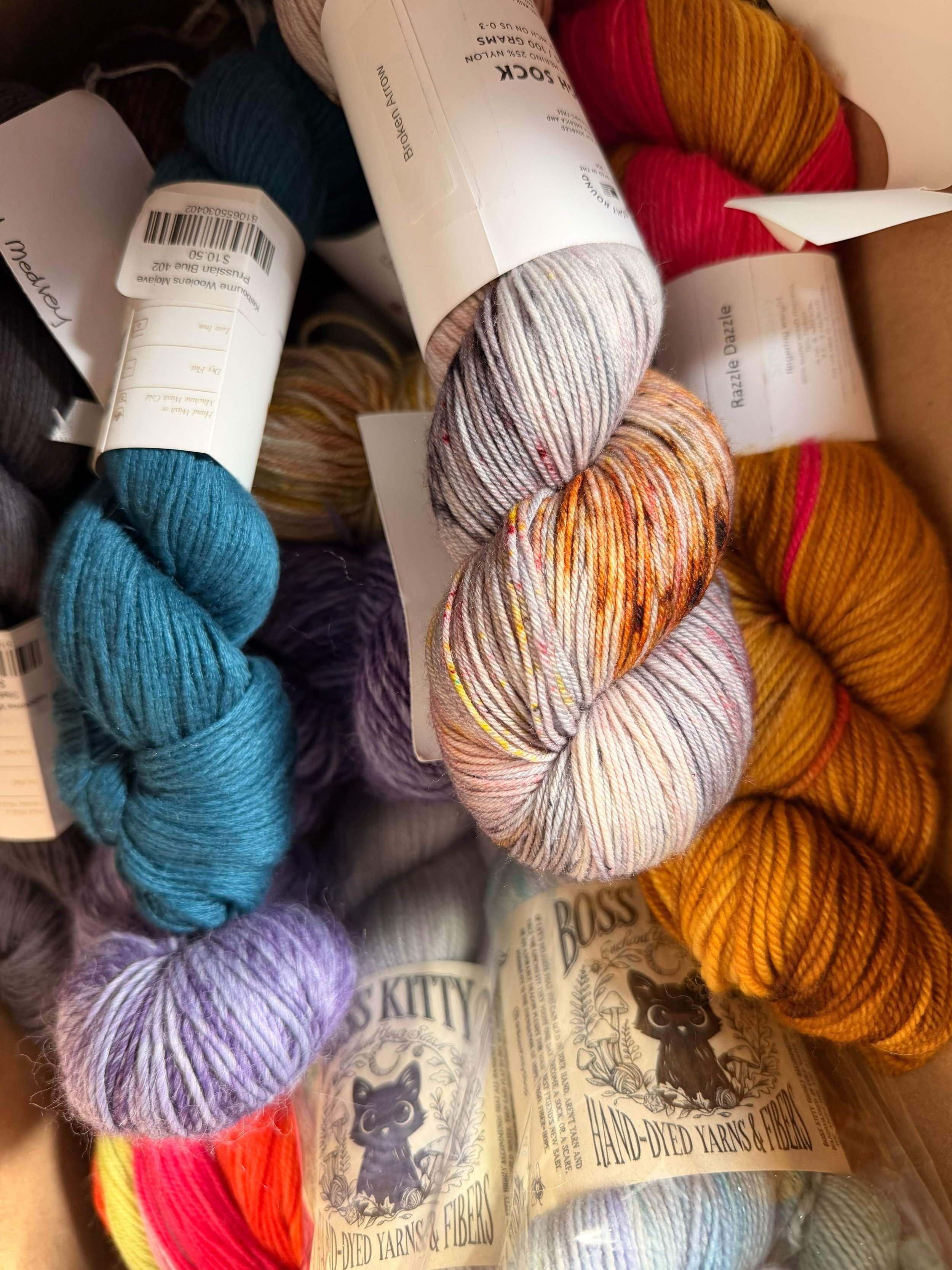Pile of brightly dyed yarn skeins.