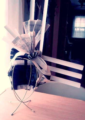 Window blinds, newspaper & eraser hat by Jill Rust