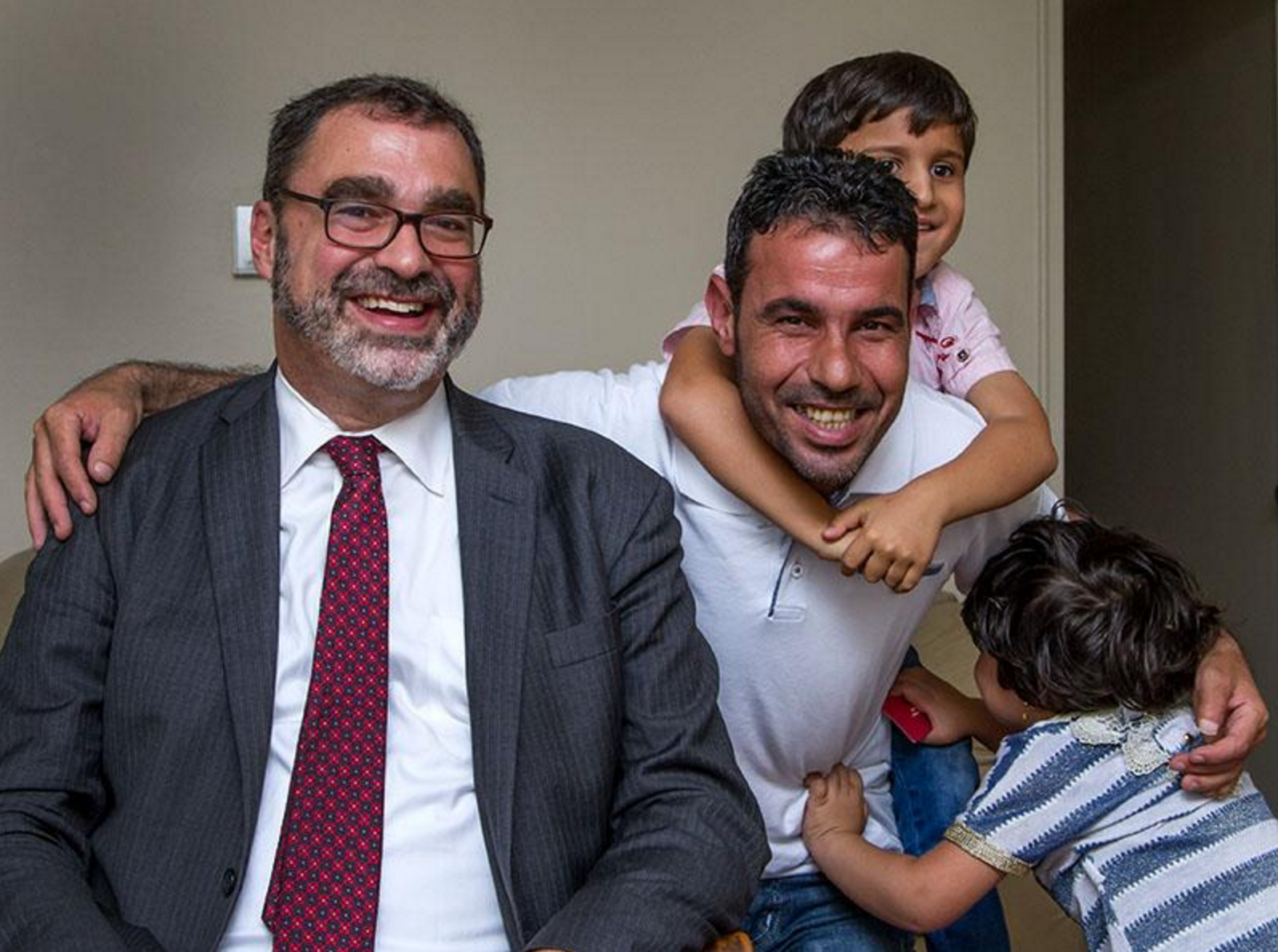 Mark Hetfield with resettled Syrian refugee Omar and his children during a visit with resettled Syrian families in Toledo, Ohio. Photo Christie Materni