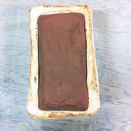 thoroughly press clay into mold
