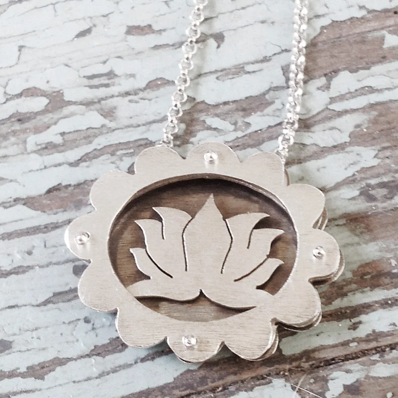 Large scalloped shadowbox necklace with lotus flower.