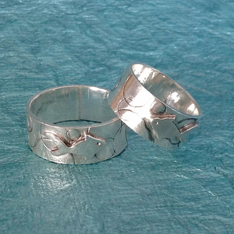 Matching sterling silver fish wedding bands.