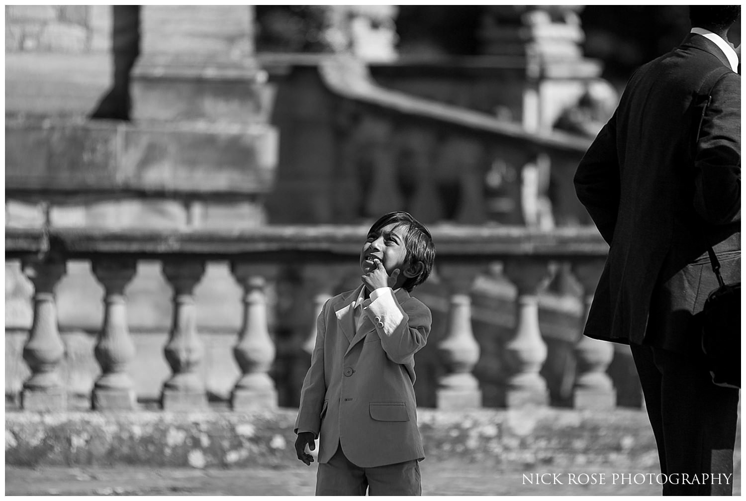  Boy standing in the Italian garden before a Hever Castle wedding in Kent 