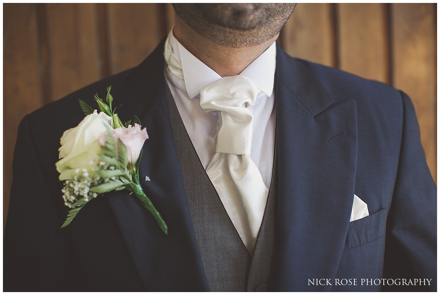  Groom with cream boutonniere getting ready for a Hever Castle wedding in Kent 