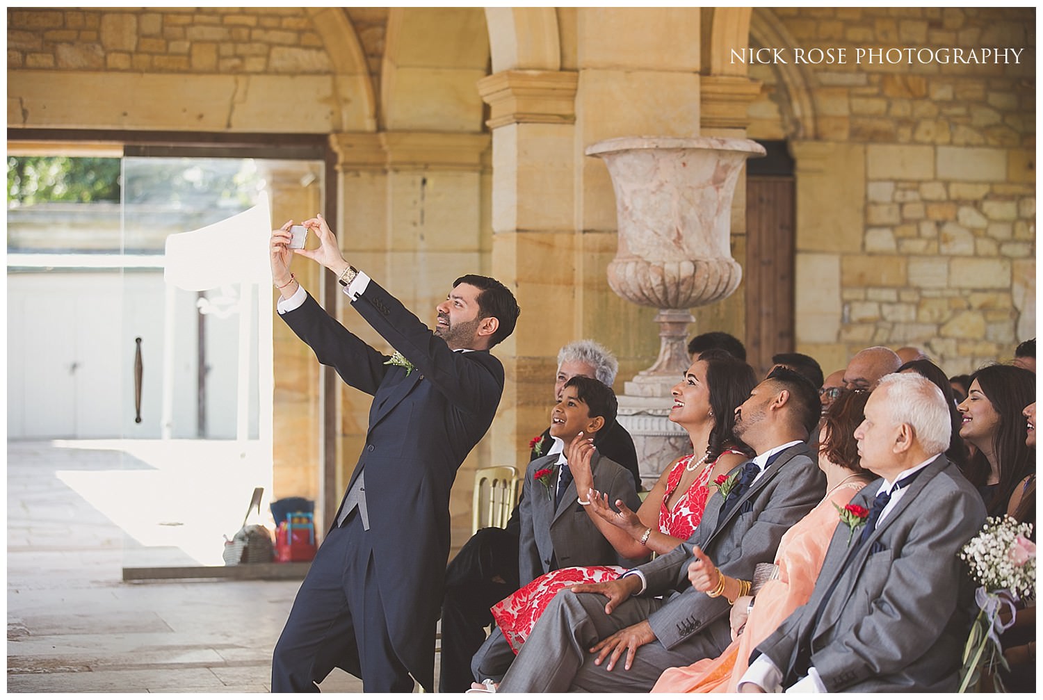  Groom taking a selfie with guests before a Kent wedding ceremony 