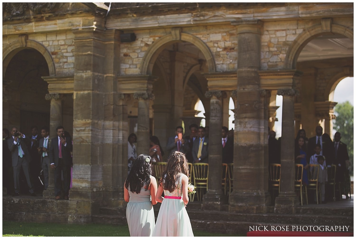  Bridesmaids walking up the aisle for an outdoor kent wedding at Hever 