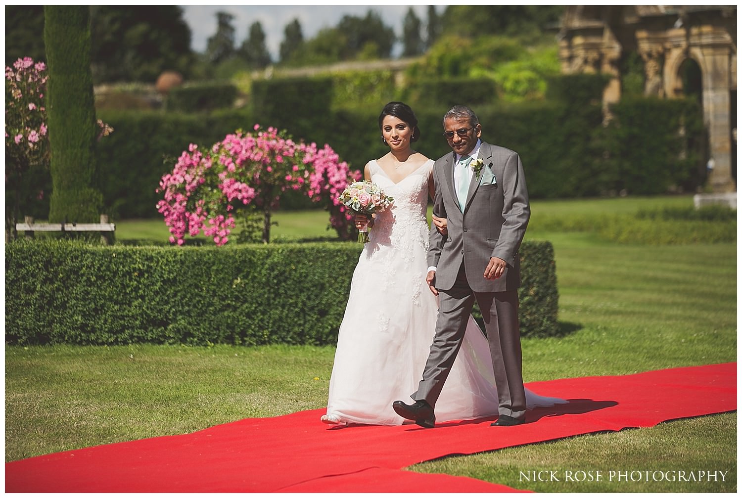  Father of the bride walking daughter up the red carpet aisle at hever castle  
