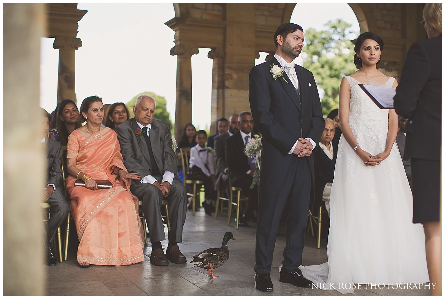  Bride and groom and ducks during a Hever Castle garden wedding in Kent 