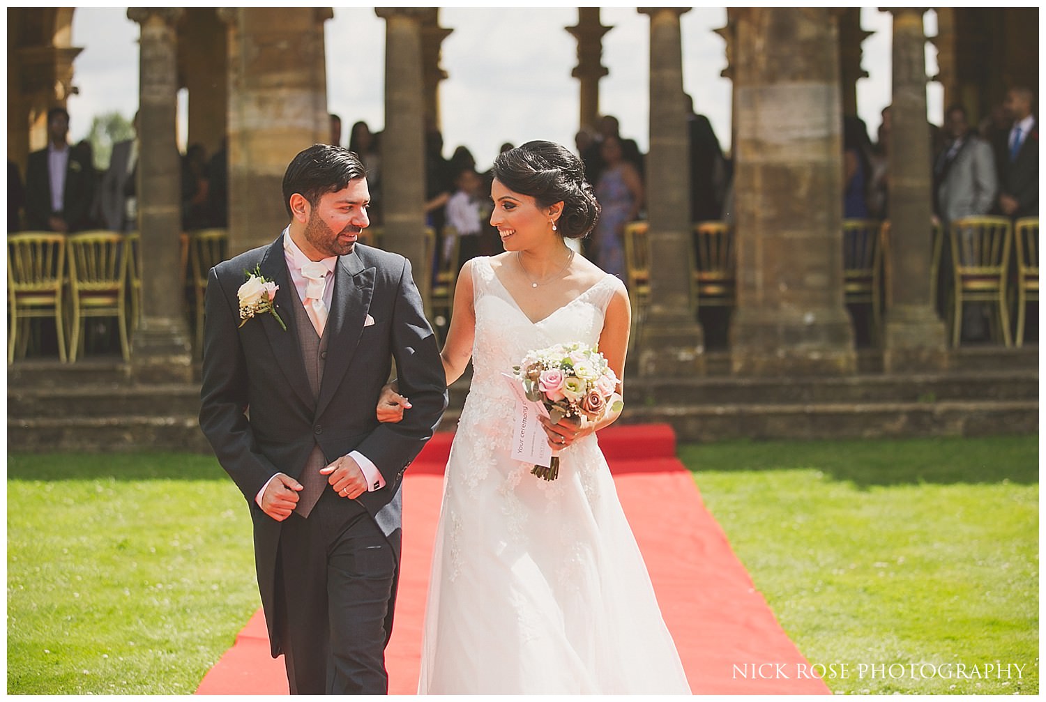  Bride and groom walking down the aisle after a wedding ceremony at Hever Castle Kent 
