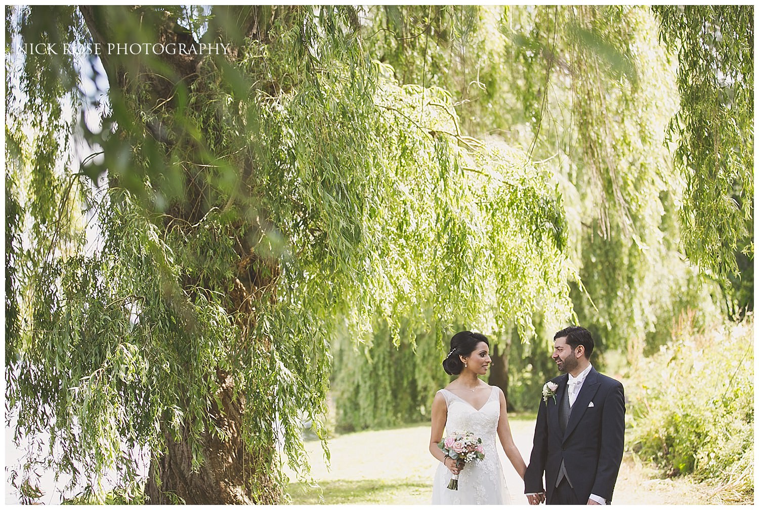  Bride and groom wedding portrait photograph under a willow tree at Hever Castle Kent 