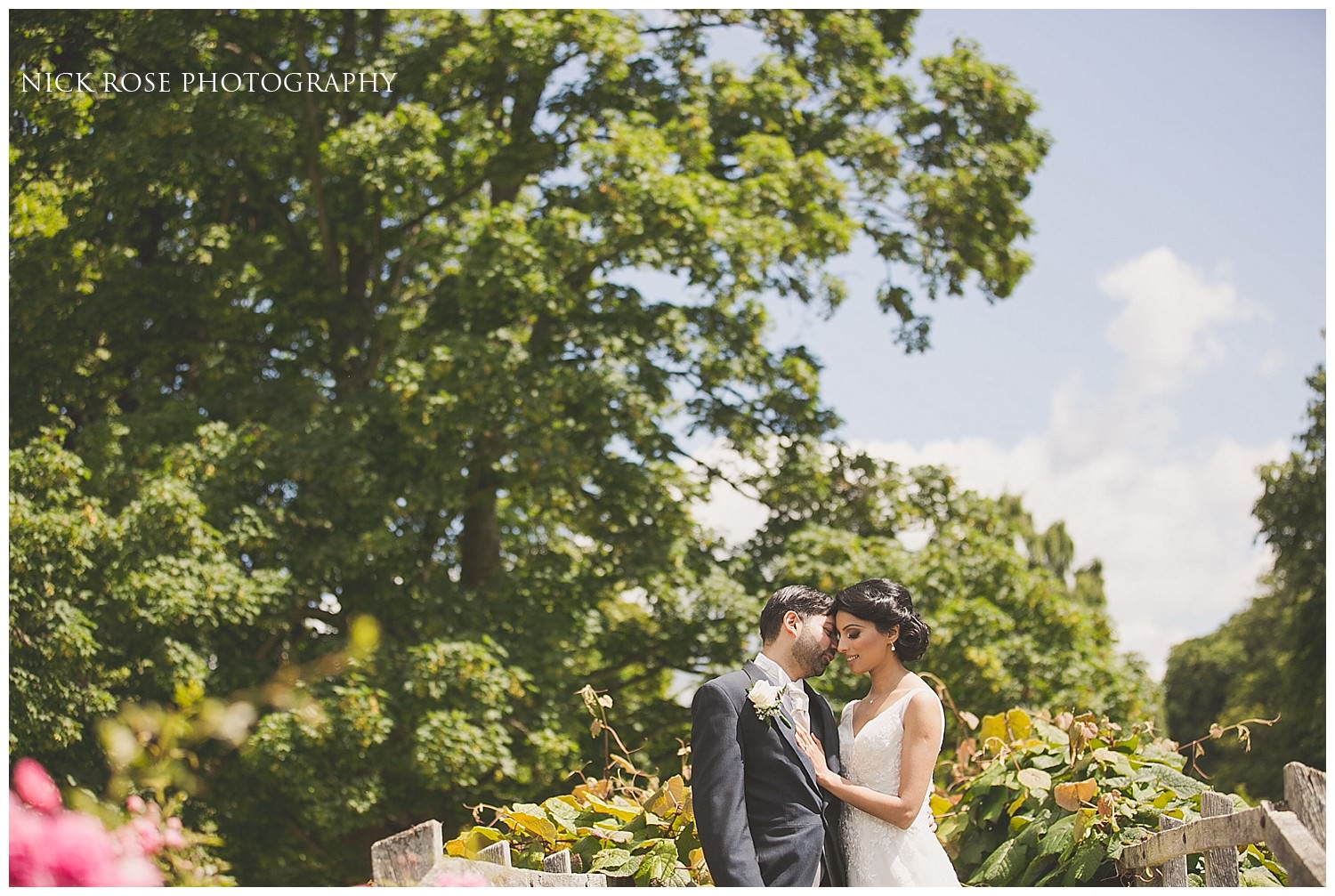  Bride and groom kissing in the Hever Castle gardens in Kent 