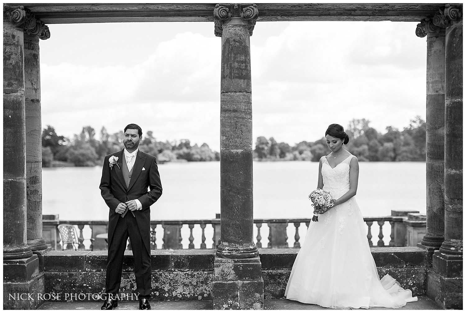  Bride and groom stading by the lake at Hever Castle Kent 