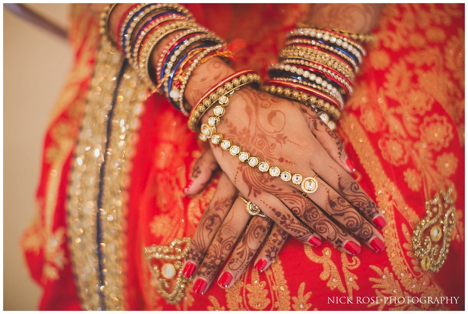  Indian bride with hands crossed on lap for an East Wintergarden wedding in Canary Wharf London 