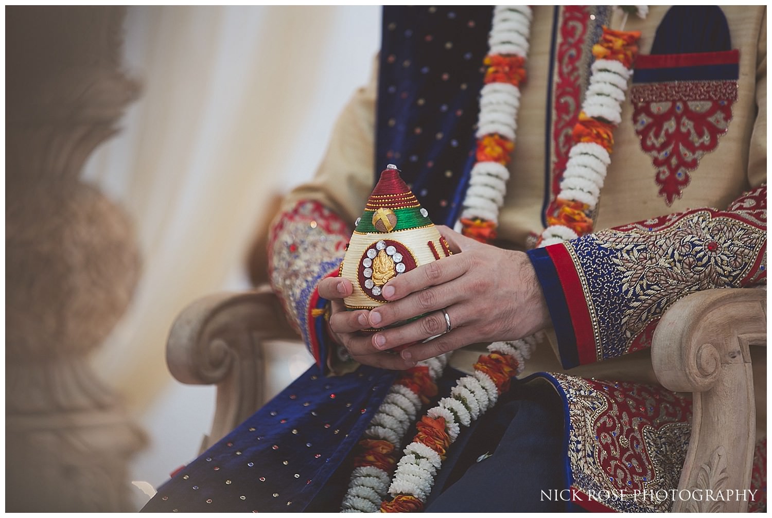  Close up photograph of groom's hands during a Hindu ceremony at East Wintergarden in Canary Wharf 