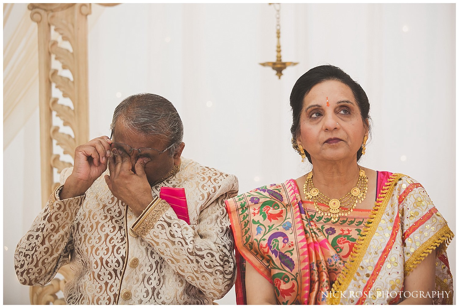  Father of the bride crying during his daughters wedding entrance at East Wintergarden Hindu wedding in Canary Wharf London 