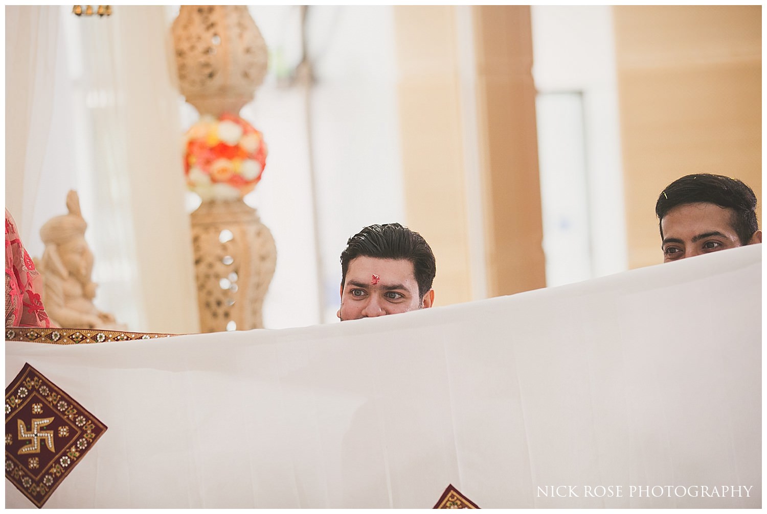  Groom seing his bride for the first time at an East Wintergarden Hindu wedding in Canary Wharf London 