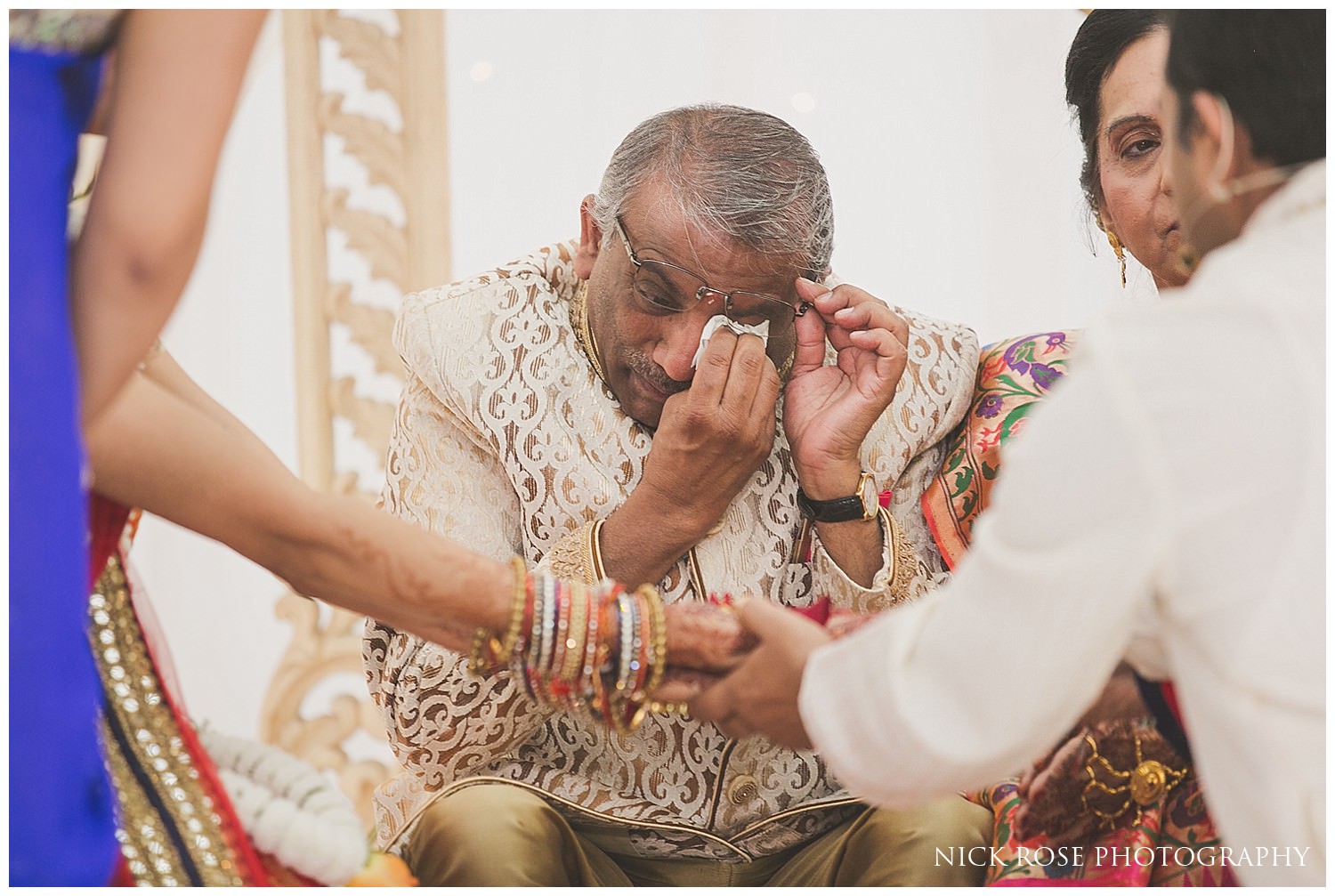  Brides father shedding a tear during an East Wintergarden Hindu wedding ceremony in Canary Wharf London 