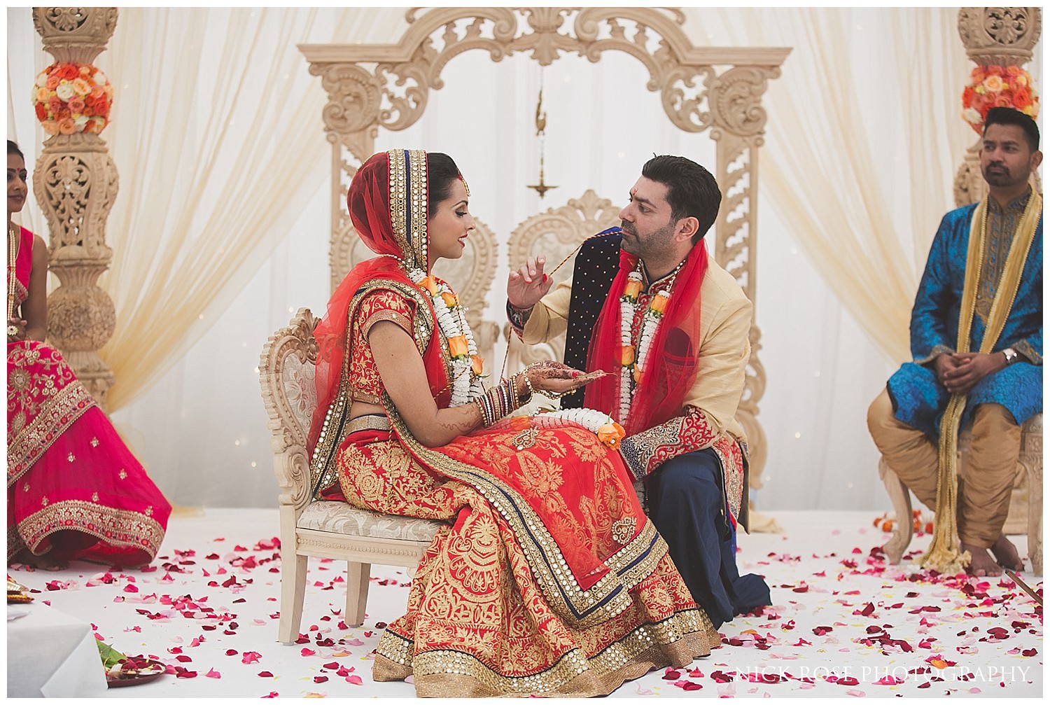  Bride and groom during their Asian Hindu wedding in the East Wintergarden at Canary Wharf London 