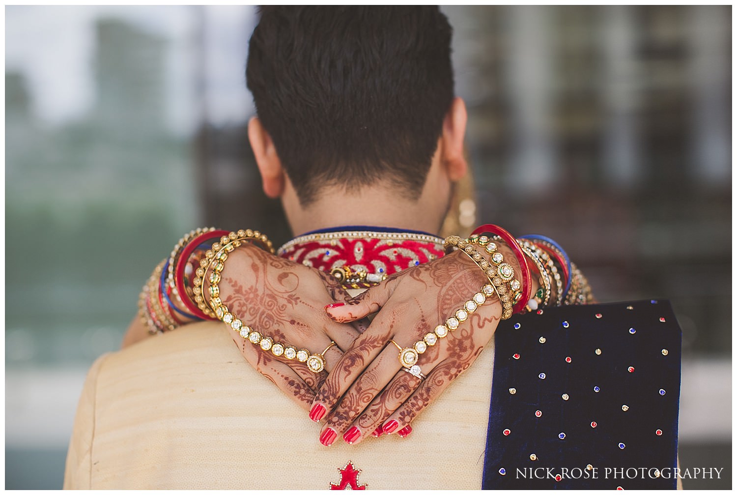  Indian bride with her hands over her grooms shoulders 