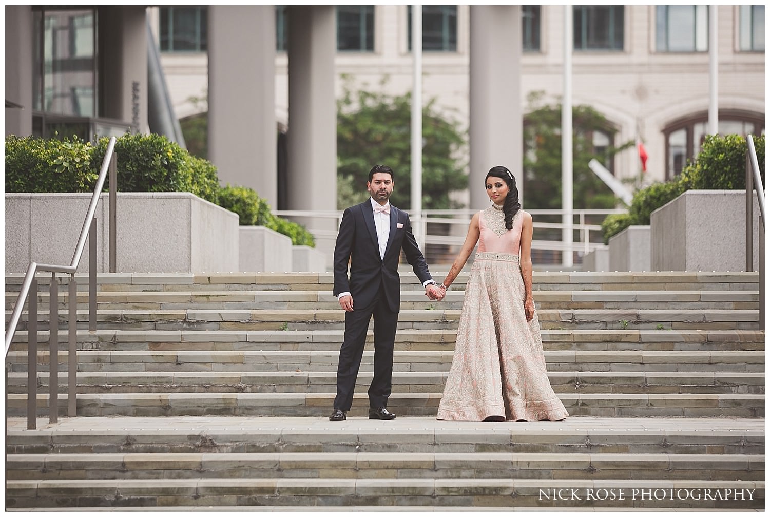  Asian bride and groom photograph before their Indian wedding reception in Canary Wharf London 