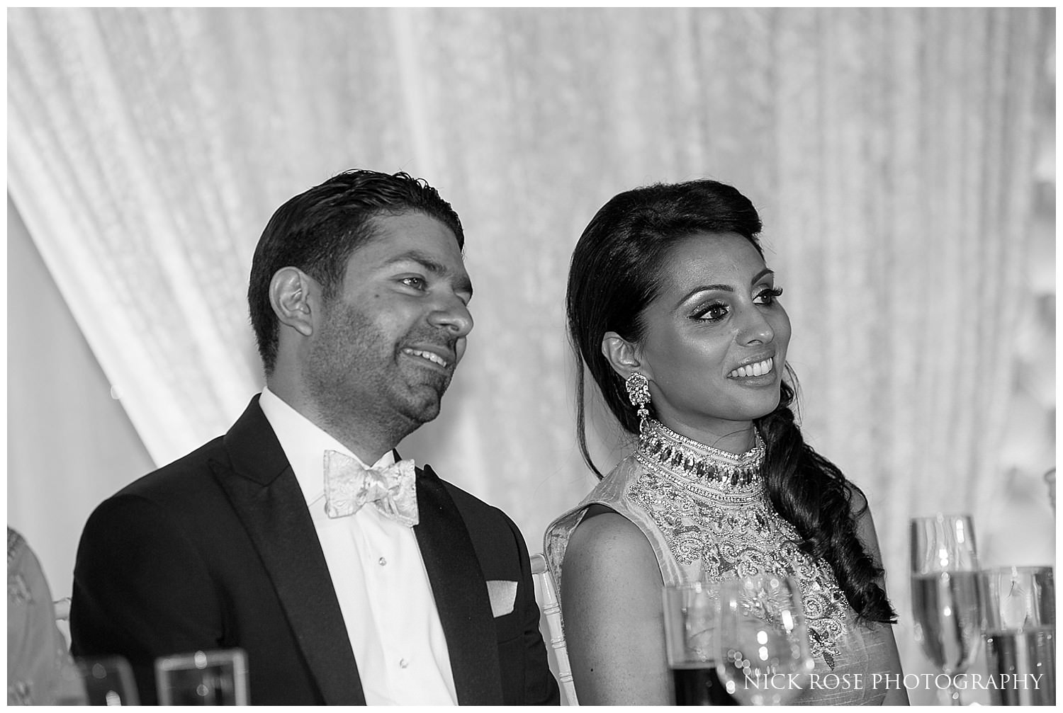  Couple listening to speeches during an Indian wedding reception in Canary Wharf London 