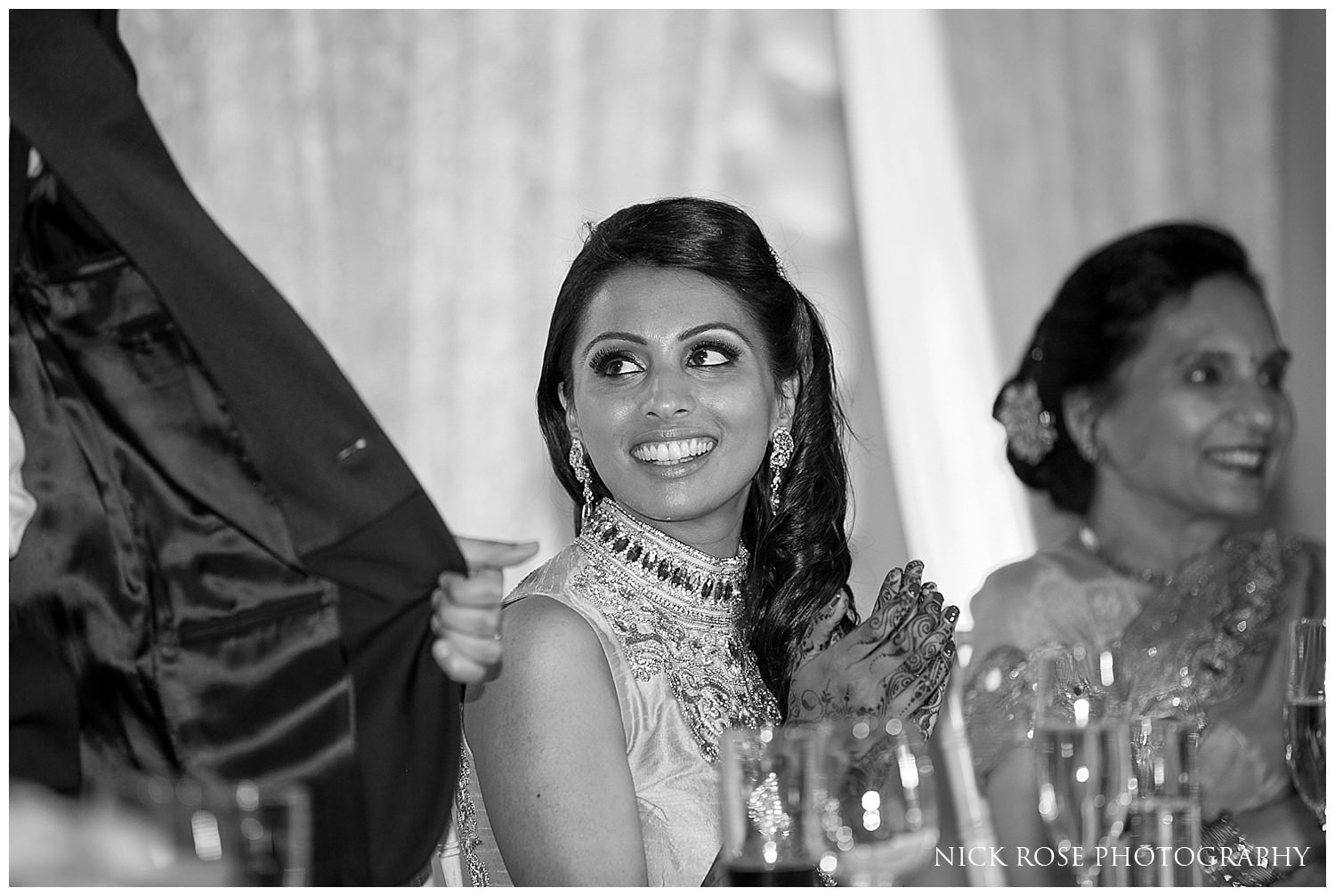  Bride smiling during an Indian wedding reception in Canary Wharf London 