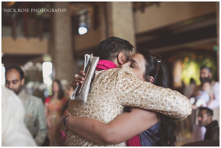  Hindu groom hugging a guests before a Dubai destination wedding 