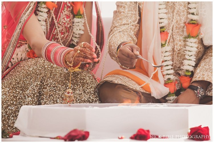  Hindu wedding couple feeding the fire during a destinaiton Indian wedding at the Sofitel Palm Dubai 