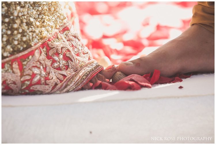 Bride and groom making the 7 vows during a destination Hindu wedding on the beach in Dubai