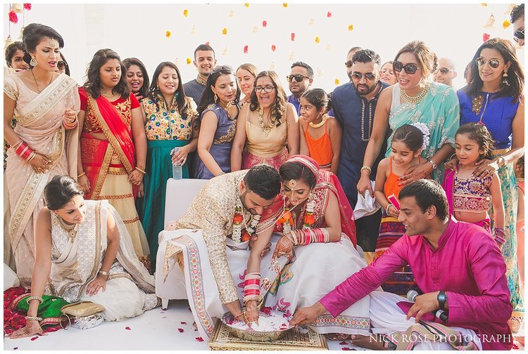 Indian couple fishing for rings during the Koda Kodi wedding ritual in Dubai