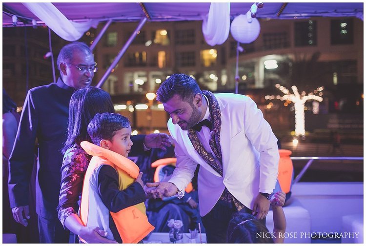  Young boy wearing a lifejacket for a private yacht wedding reception in Dubai 