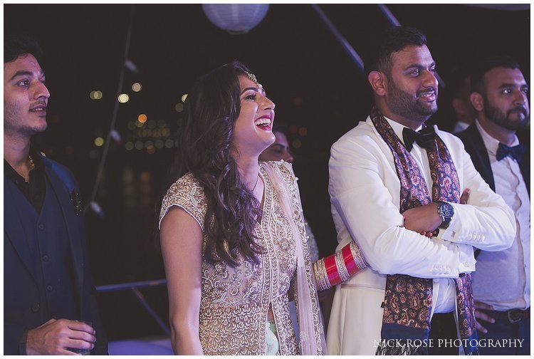  Bride and groom laughing during wedding speeches in Dubai 