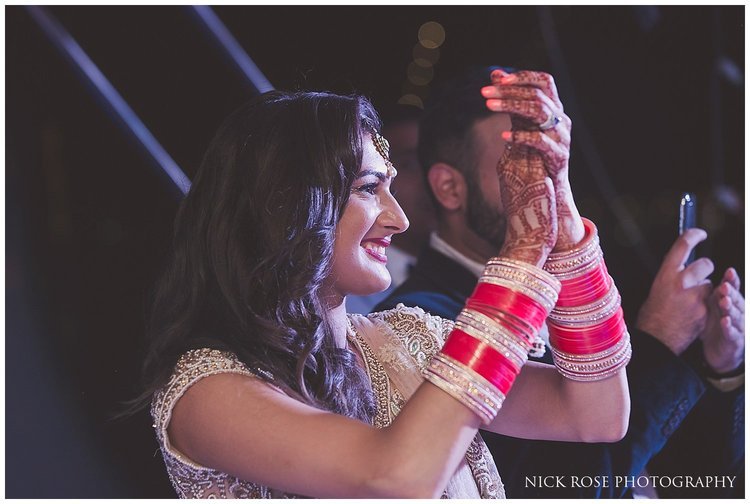  Bride clapping at a destination Hindu wedding reception on a yacht in Dubai 