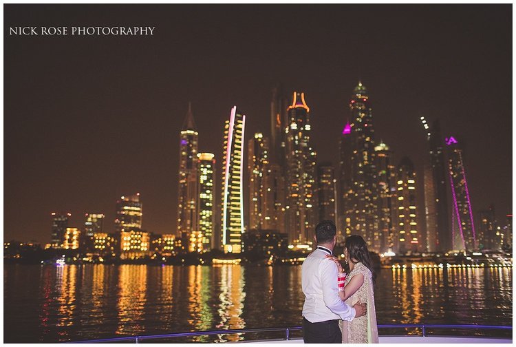  Asian destination wedding couple night portrait in front of the Dubai city skyline 